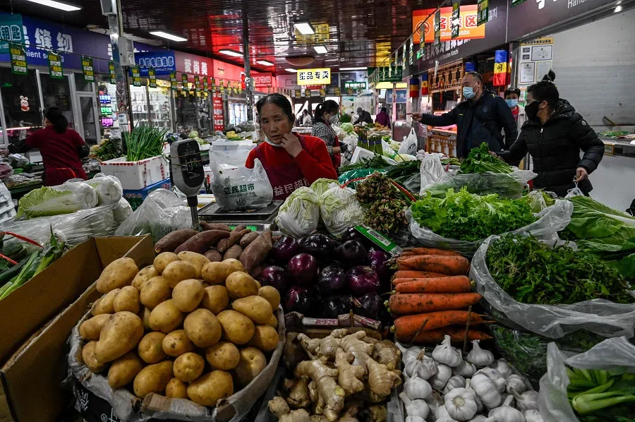 A woman sells vegetables at a market in Beijing, China, on 9 March 2023. (Jade Gao/AFP)