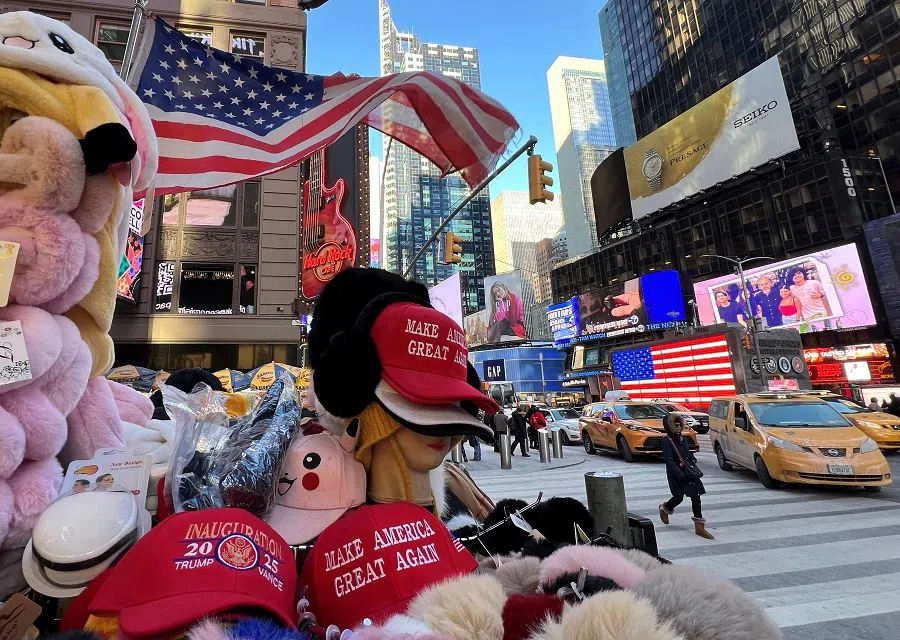 “Make America Great Again” hats are displayed at a souvenir stall in Times Square, in New York City, US, 24 January 2025. (Fabrizio Bensch/Reuters)