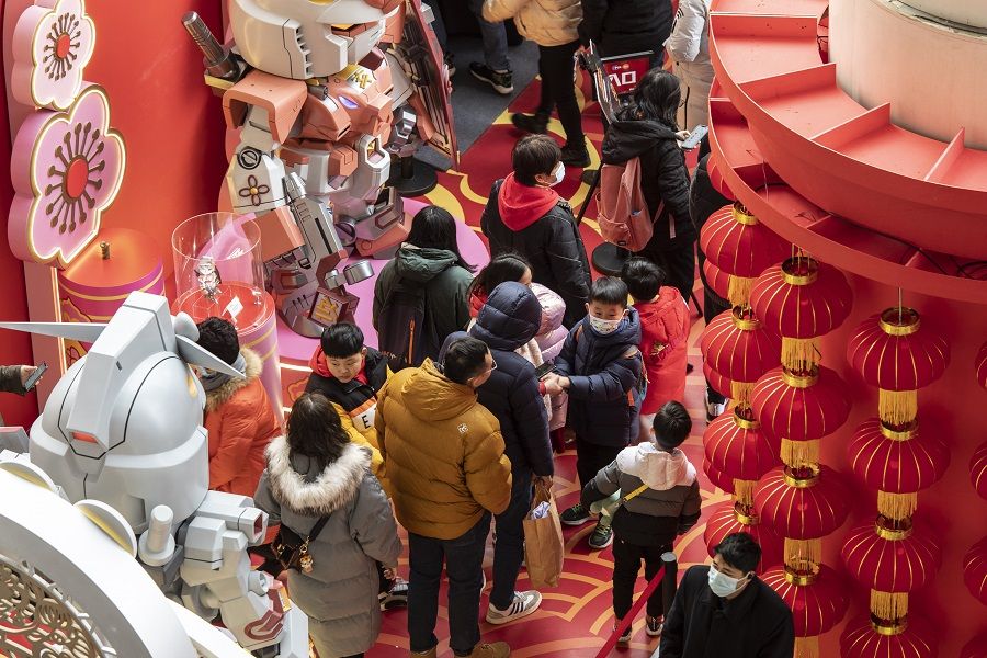 Visitors look at festive installations for Chinese New Year in Shanghai, China, on 2 February 2022. (Qilai Shen/Bloomberg)