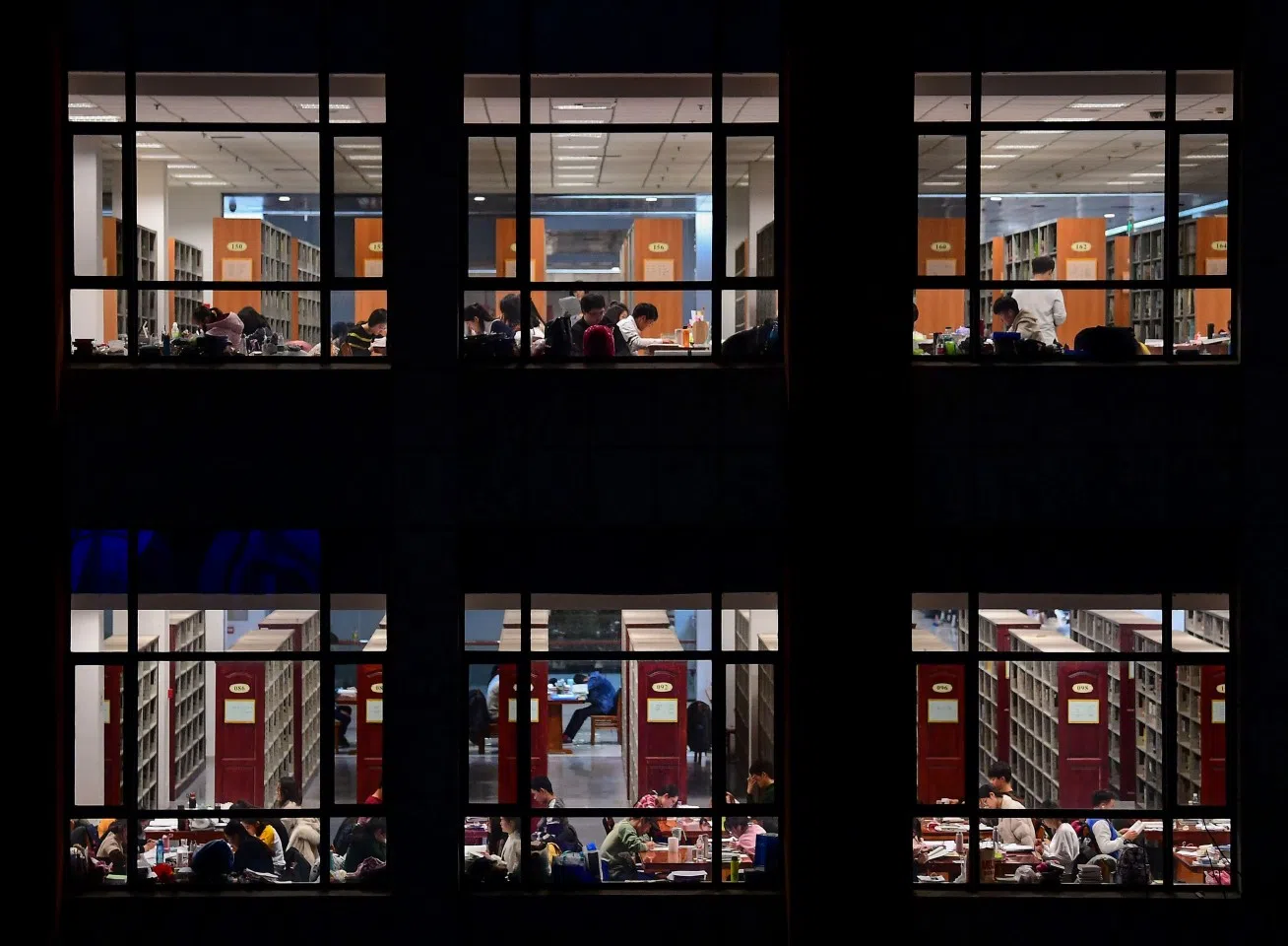 This photo taken on December 18, 2018 shows university students preparing for the upcoming National Postgraduate Entrance Exam (NPEE) at a library of the Shenyang Agricultural University in Shenyang, Liaoning province. (STR/AFP)