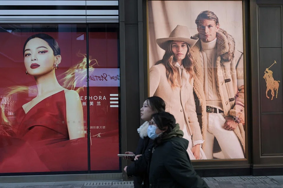 People walk at a shopping mall in Beijing, China, on 16 January 2024. (Pedro Pardo/AFP)