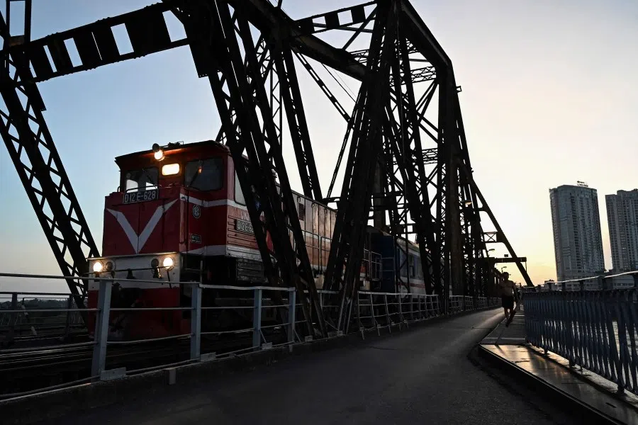 A train runs on the Long Bien bridge in Hanoi on 12 July 2023. (Nhac Nguyen/AFP)