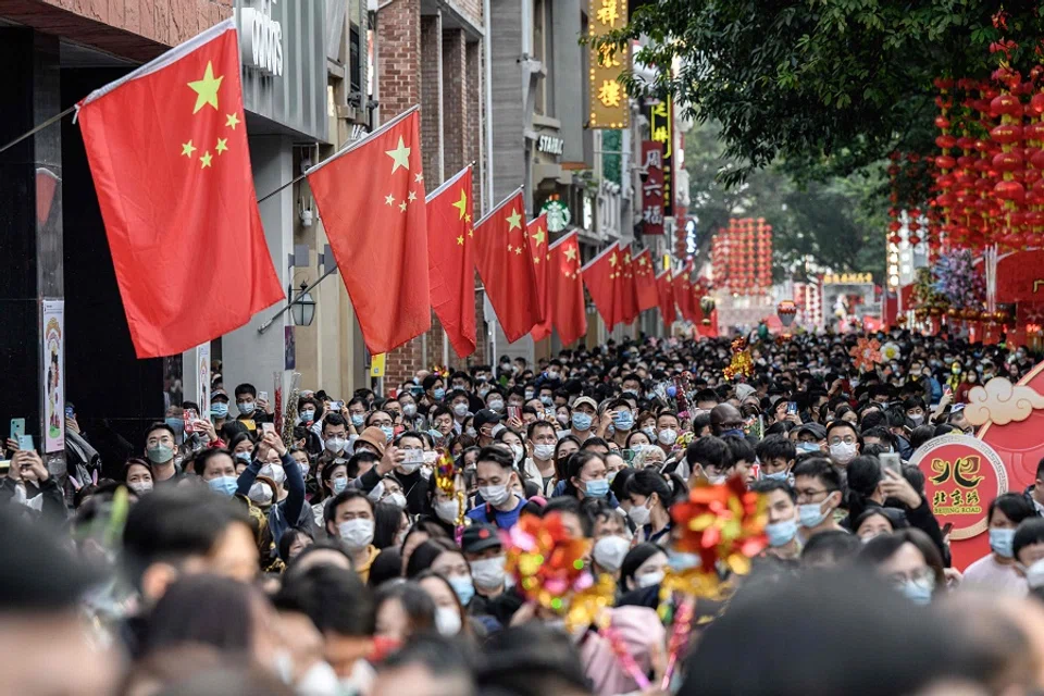 People visit a traditional Spring Festival flower market which reopened after closure due to the spread of the Covid-19 coronavirus in Guangzhou, Guangdong province, China, on 20 January 2023. (AFP)
