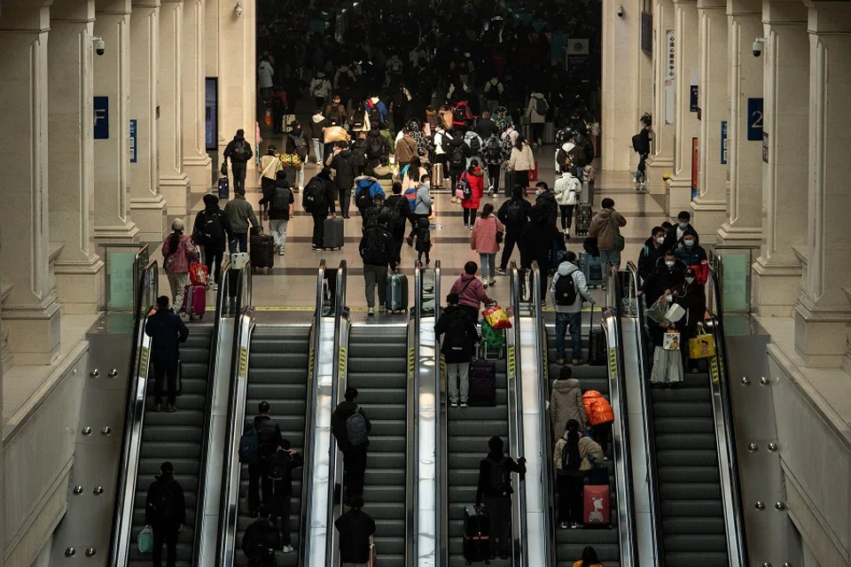 This photo taken on 10 December 2022 shows passengers arriving at Hankou Railway Station in Wuhan, Hubei province, China. (AFP)