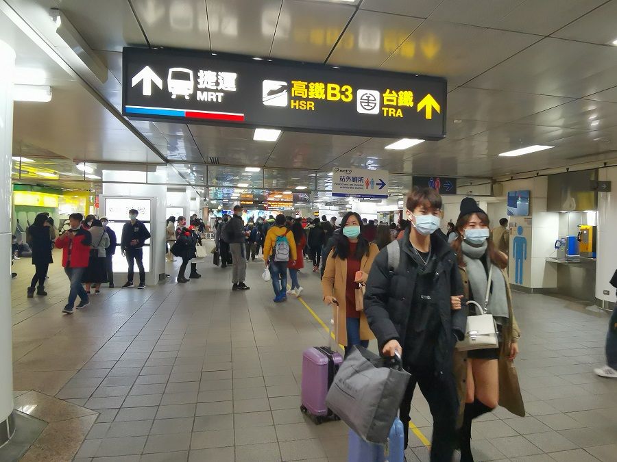 Commuters walk in a busy station in Taiwan.