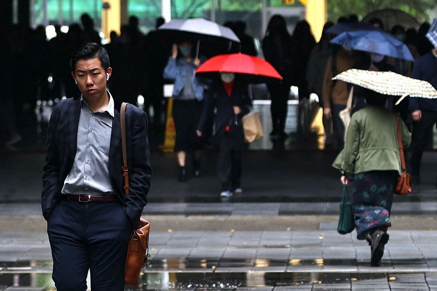A man walks in Taipei, Taiwan, 1 December 2022. (Ann Wang/Reuters)