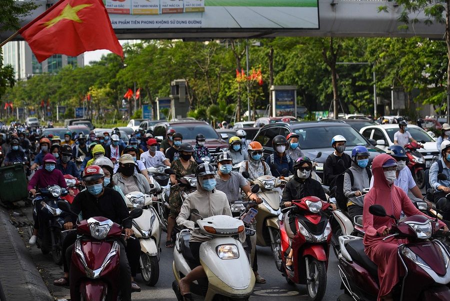 Motorists travel along a road in Hanoi, Vietnam on 2 June 2021. (Nhac Nguyen/AFP)