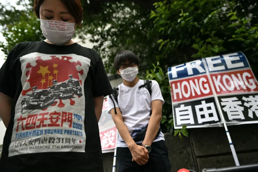 Pro-democracy activists hold a silent prayer before a protest at the Chinese embassy to mark the 31st anniversary of the Tiananmen incident on 4 June 1989, in Tokyo on 4 June 2020. (Philip Fong/AFP)