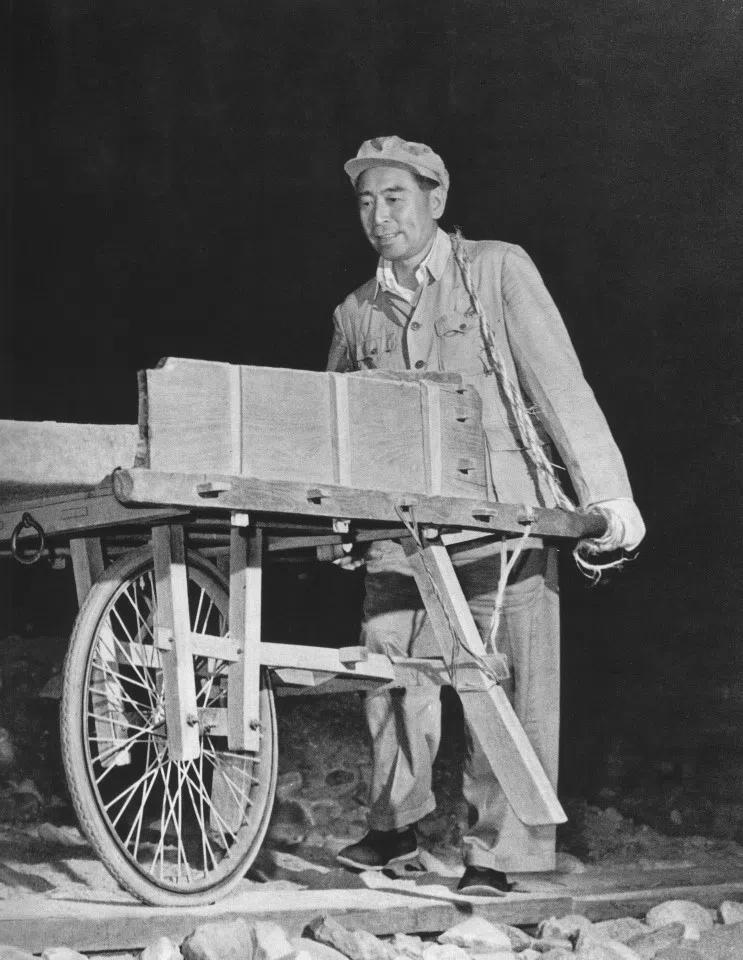 A propaganda photo of Communist leader Zhou Enlai participating in labour, 1958.