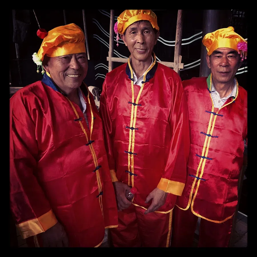 Colourfully attired for the occasion of a local festival, these performers pose for a photo in the town of Qiantong in Ninghai, Zhejiang.