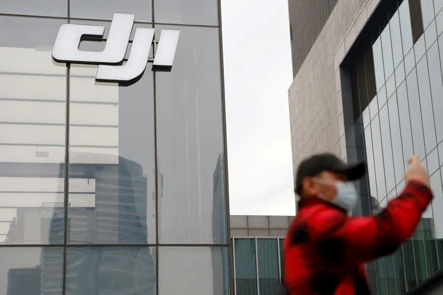 A man stands outside a store of Chinese drone maker DJI in Beijing, China, on 15 December 2021. (Carlos Garcia Rawlins/Reuters)