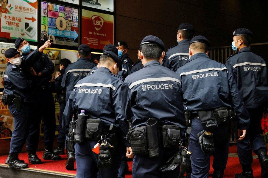 Police are seen outside the Stand News office building, in Hong Kong, China, 29 December 2021. (Tyrone Siu/File Photo/Reuters)