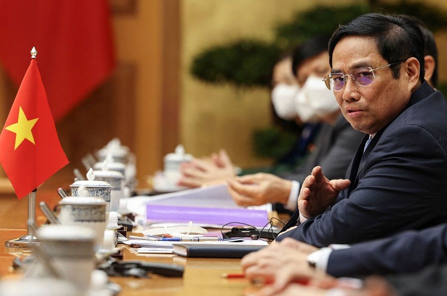 Vietnamese Prime Minister Pham Minh Chinh reacts during a meeting with US Vice President Kamala Harris (not pictured) at the Office of Government, in Hanoi, Vietnam, 25 August 2021. (Evelyn Hockstein/Pool/AFP)