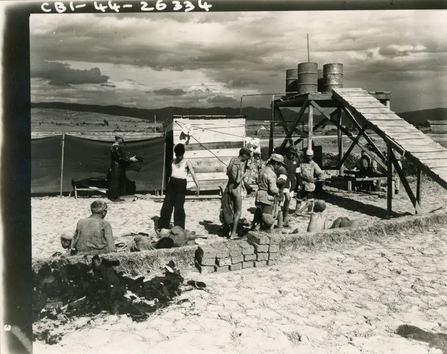 Chinese patients queuing to shower outside a field hospital.