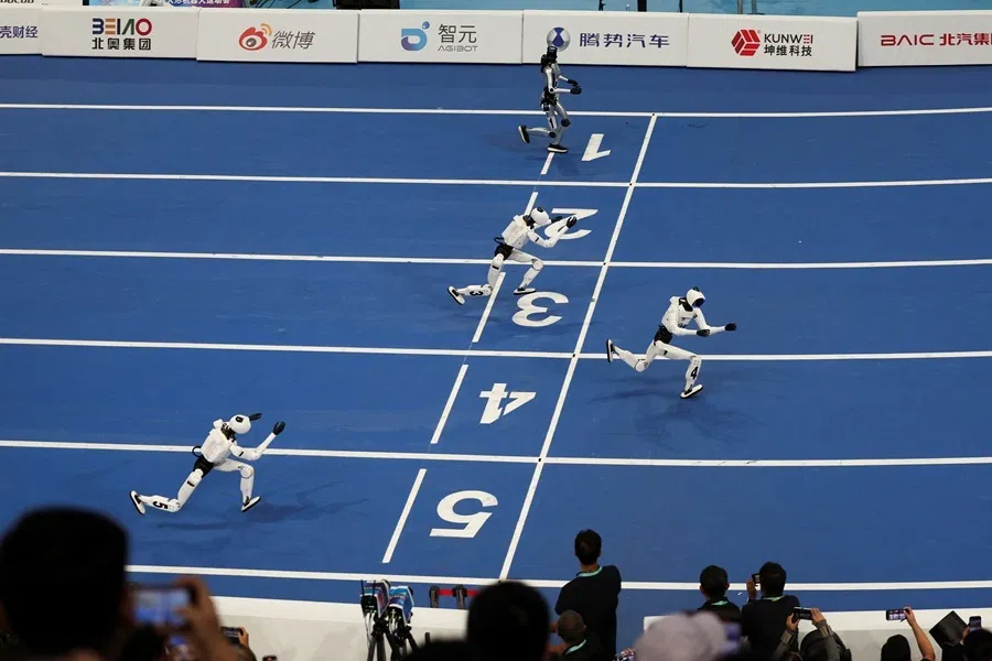 Tiangong Omni humanoid robots and Honor’s humanoid robot compete in the 100m small-size group final race, at the 2026 World Humanoid Robot Games at the National Speed Skating Oval in Beijing, China, on 26 August 2026.