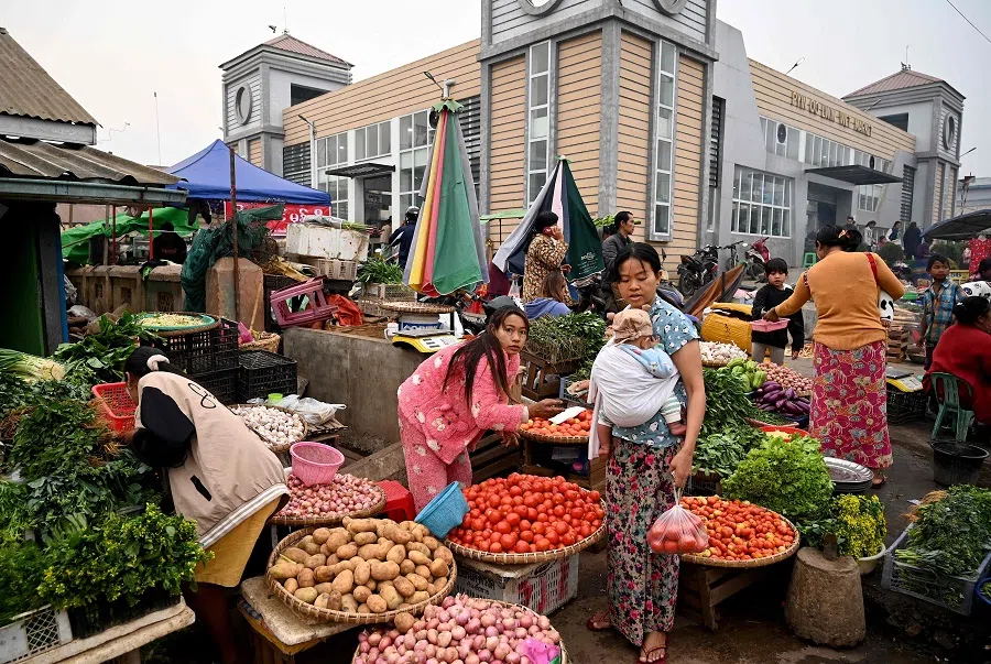 A vendor sells vegetables at a street market in Pyin Oo Lwin township in Myanmar’s Mandalay region on 11 March 2023. (AFP)