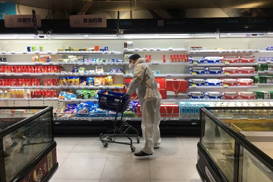 A customer pushes a cart while shopping inside a supermarket of Alibaba's Hema Fresh chain, following a Covid-19 outbreak in Wuhan, Hubei province, China, on 11 February 2020. (Stringer/Reuters)