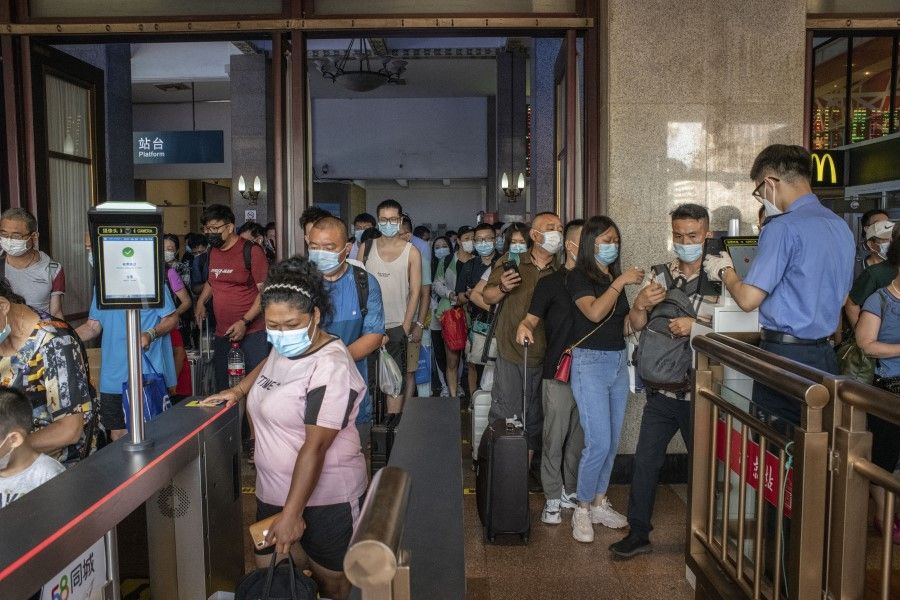 Arriving travelers have their health codes checked before exiting Beijing Railway Station in Beijing, China, on 9 August 2021. (Gilles Sabrie/Bloomberg)