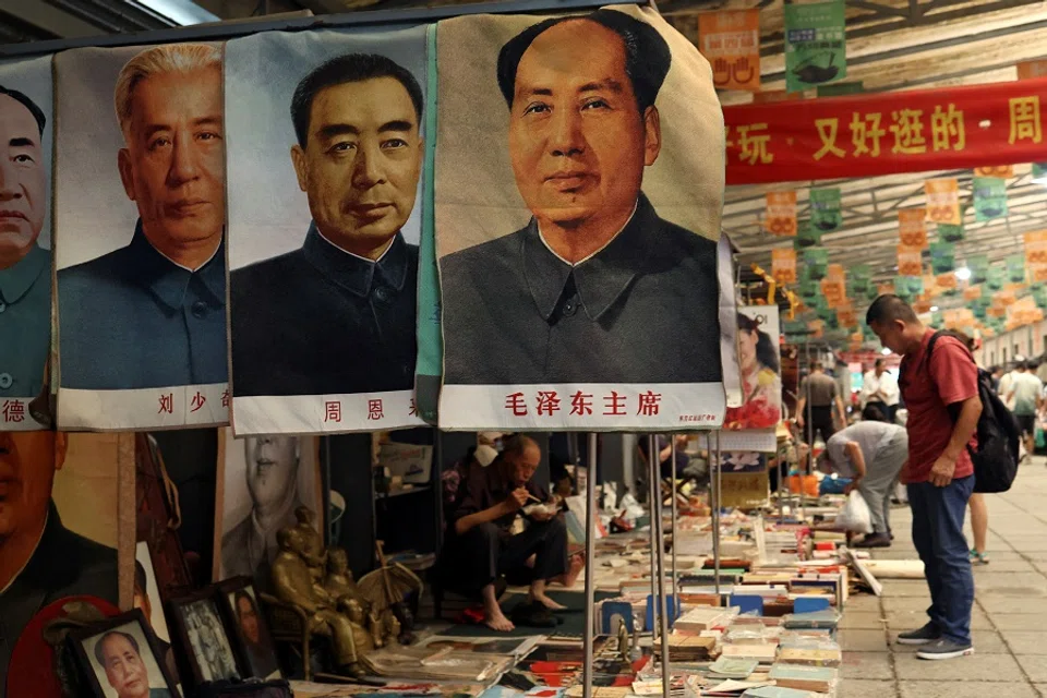 Posters depicting late Chinese chairman Mao Zedong and other former Chinese leaders are displayed for sale at the secondhand books section of Panjiayuan antique market in Beijing, China on 3 August 2024. (Florence Lo/Reuters)