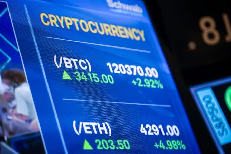 A television broadcasts cryptocurrency market information on the floor at the New York Stock Exchang in New York, US, on 11 August 2025. (Michael Nagle/Bloomberg)