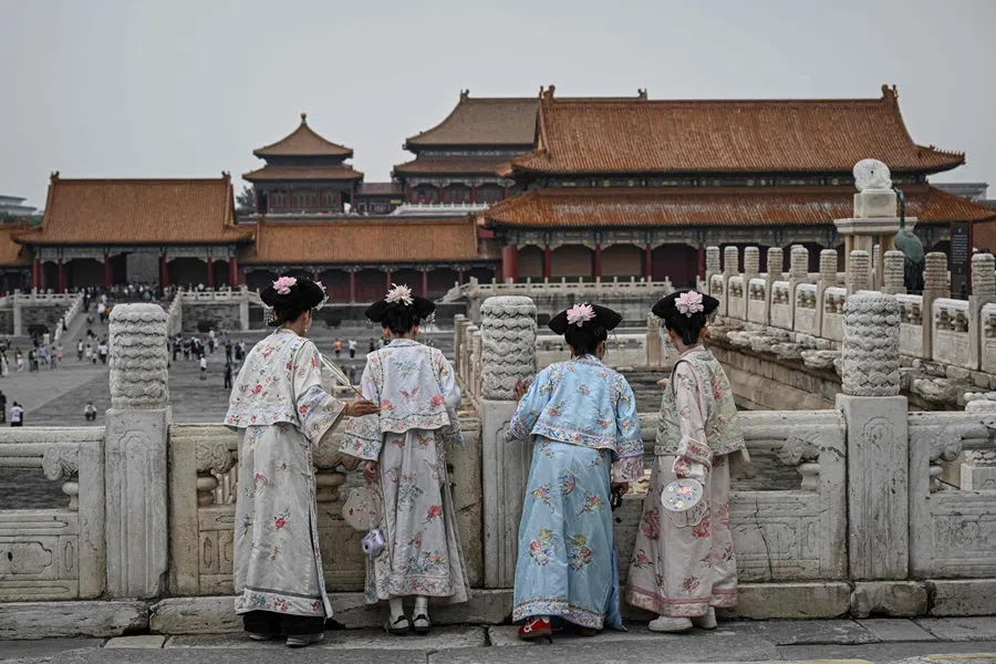 People dressed in traditional costumes visit the Forbidden City in Beijing on 10 September 2025. (Jade Gao/AFP)