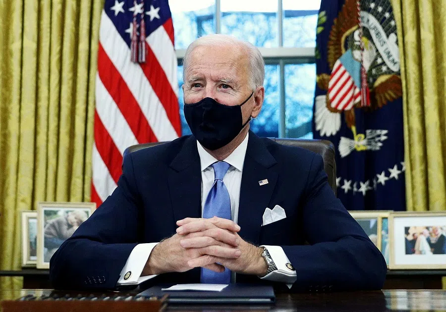 US President Joe Biden signs executive orders in the Oval Office of the White House in Washington, after his inauguration as the 46th President of the United States, US, 20 January 2021. (Tom Brenner/File Photo/Reuters)