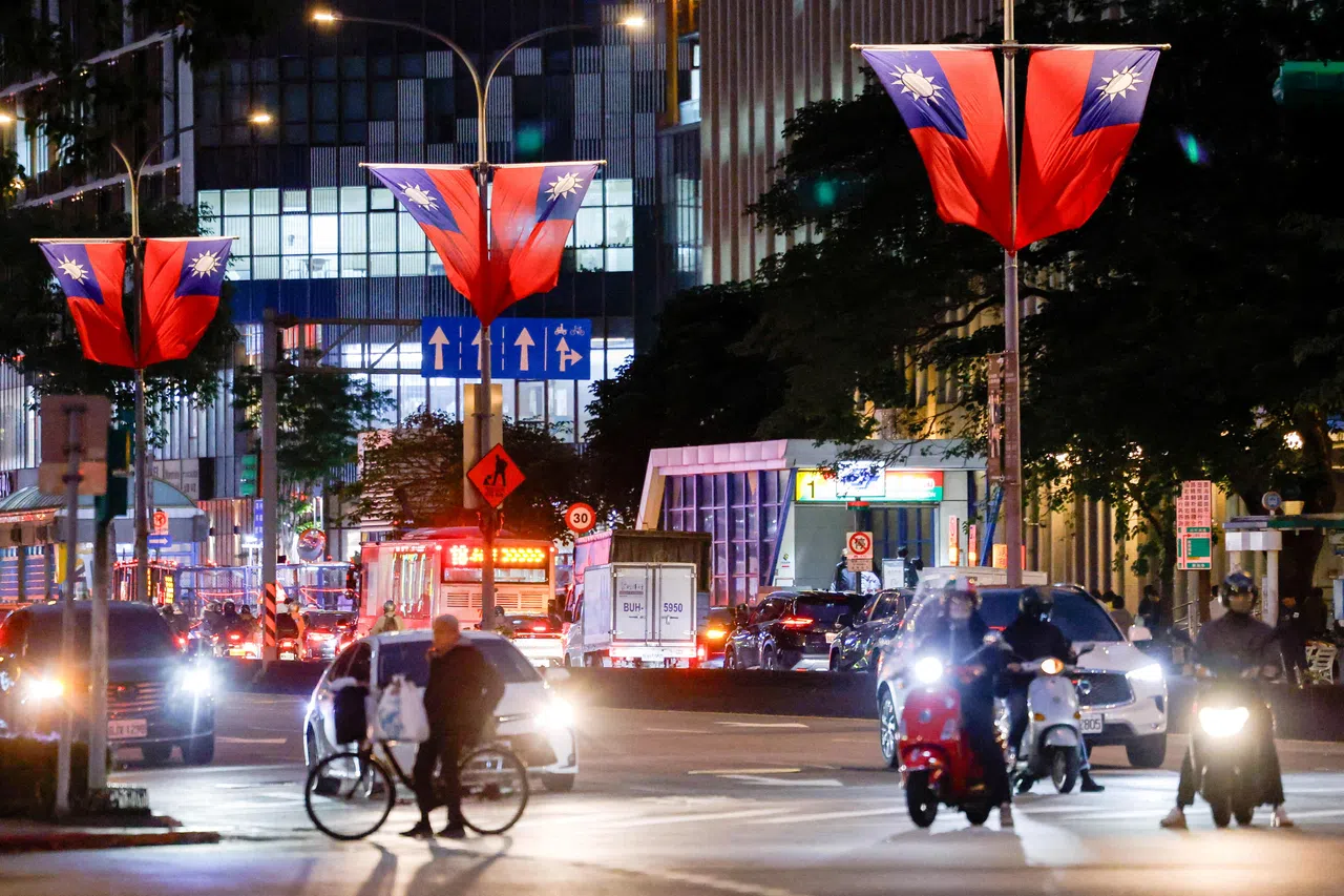 Cars and motorbikes wait at a traffic light on a street in Taipei, Taiwan, 30 December 2025.