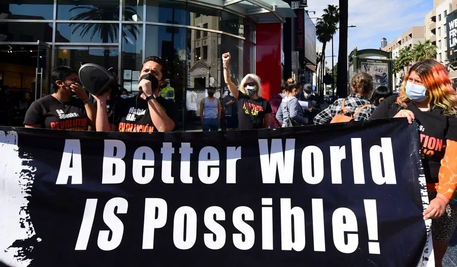 Political activists rally at the intersection of Hollywood and Highland during a protest to mark International Women's Day on 8 March 2021 in Hollywood, California. (Frederic J. Brown/AFP)