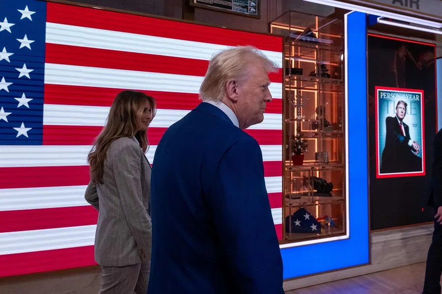 US President-elect Donald Trump walks onto the floor of the New York Stock Exchange (NYSE) with his wife Melania after being named TIME’s “Person of the Year” for the second time on 12 December 2024 in New York City.