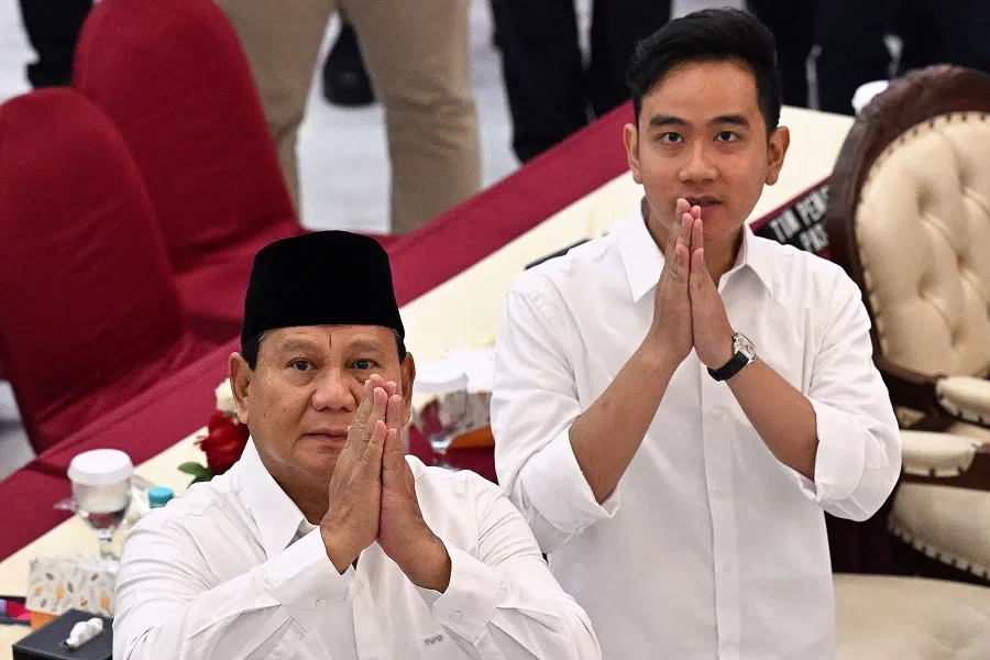 President-elect Prabowo Subianto (left) and vice president-elect Gibran Rakabuming Raka gesture as they arrive during the plenary meeting of general election commission (KPU) relating to the 2024 presidential election in Jakarta, Indonesia, on 24 April 2024. (Adek Berry/AFP)
