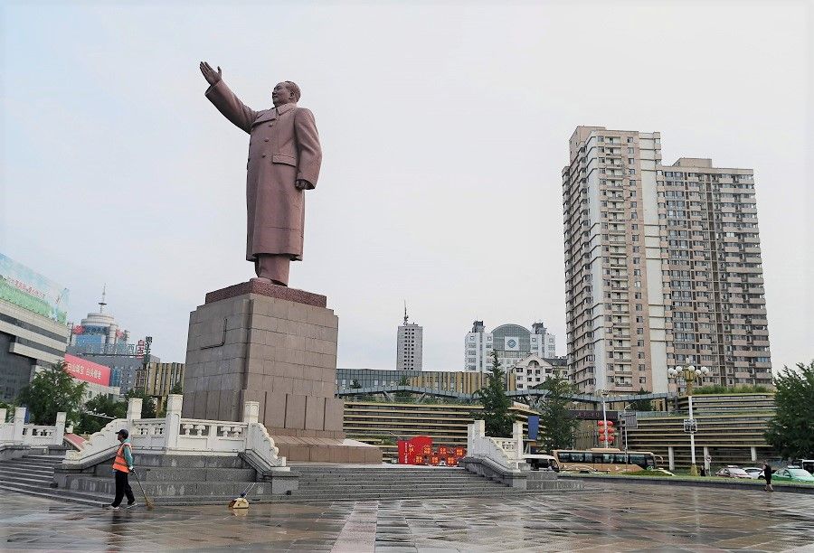 A worker stands in front of a Mao Zedong sculpture at Dandong station in Dandong, Liaoning province, China, on 11 August 2021. (Noel Celis/AFP)