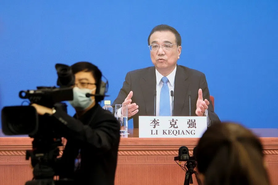 Chinese Premier Li Keqiang is seen on a screen as he attends a news conference via video link after the closing session of the National People's Congress (NPC) in Beijing, China, 11 March 2022. (Ryan Woo/Reuters)