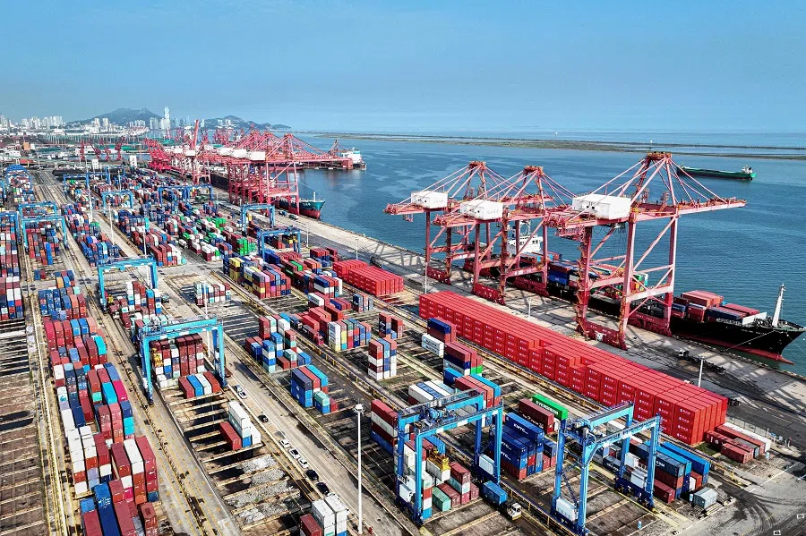 Shipping containers and gantry cranes are seen at a port in Lianyungang, in eastern China’s Jiangsu province, 7 August 2024. (AFP)