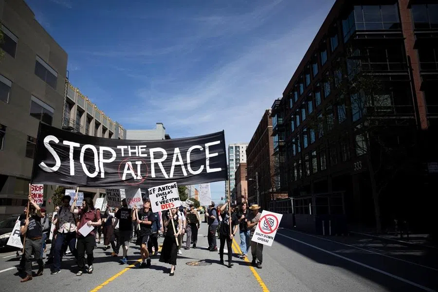 People march across San Francisco from Anthropic's headquarters to OpenAI to xAI, calling for a pause in AI development, in San Francisco, California, US, on 21 March 2026. (Manuel Orbegozo/Reuters)