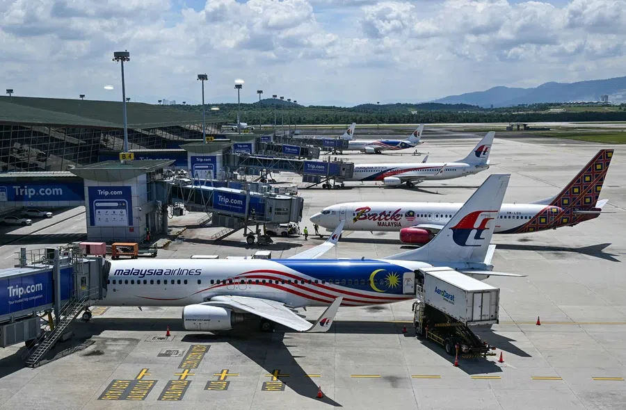 Malaysia Airlines and Batik Air aircraft are seen on the tarmac at Kuala Lumpur International Airport in Sepang on 12 August 2025. (Mohd Rasfan/AFP)