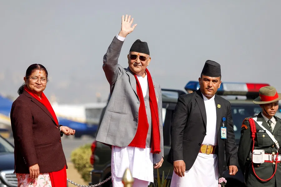 Nepal’s Prime Minister KP Sharma Oli (second from left) waves alongside his wife Radhika Shakya (left) before his departure for his first bilateral visit to China, at the Tribhuvan International airport in Kathmandu, Nepal, on 2 December 2024. 