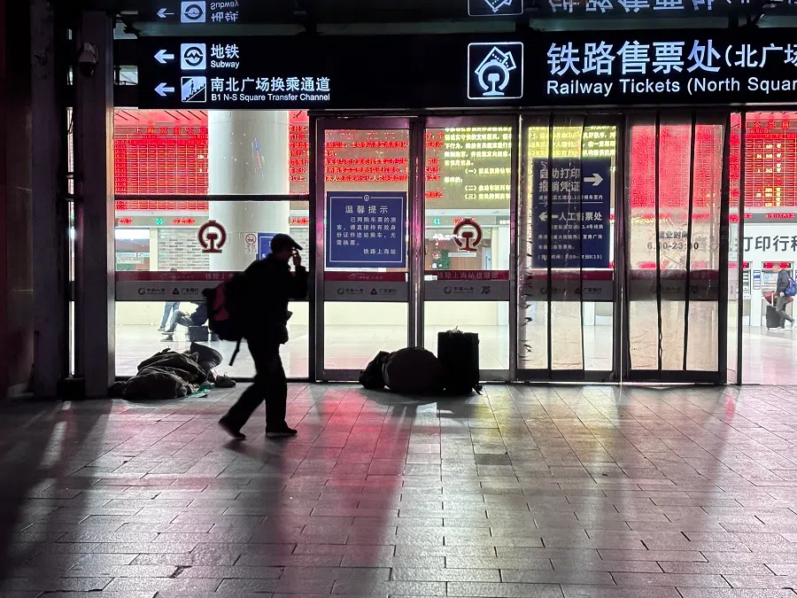 People sleeping on the street outside a train station in Shanghai. (Li Kang/SPH Media)
