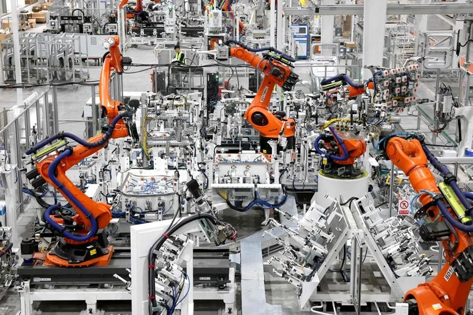 This picture shows robot arms working at the production workshop of a mould and stamping company in Fuzhou, in China’s eastern Fujian province, on 16 April 2026. (CN-STR/AFP)