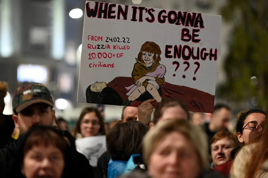 A protestor holds a sign during a demonstration in support of Ukraine, in Madrid, Spain, on 24 February 2023, on the first anniversary of Russia's invasion of Ukraine. (Oscar del Pozo/AFP)