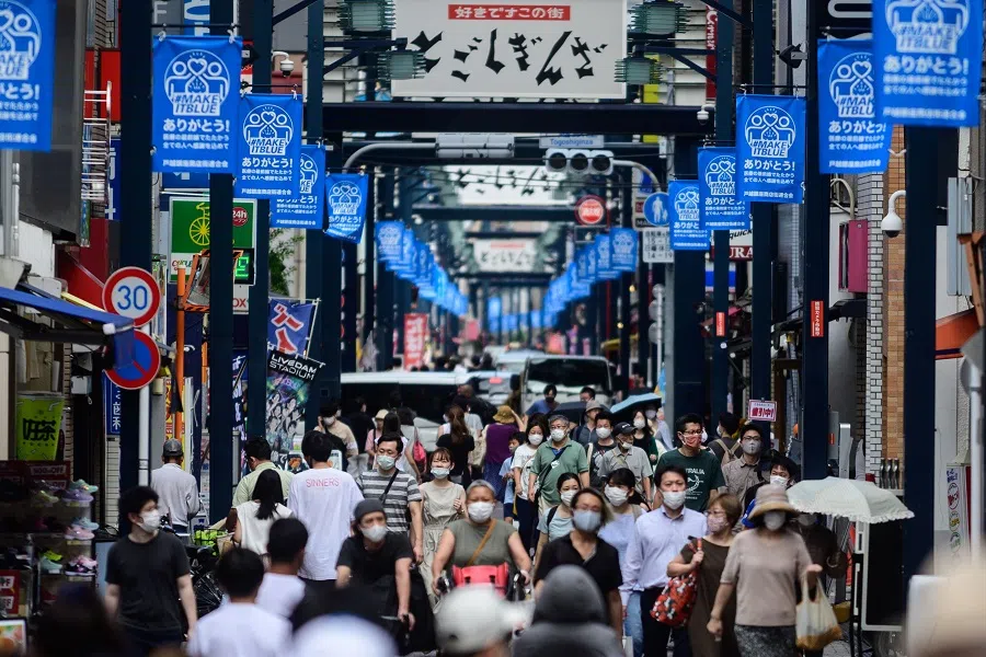 People wearing face masks as a preventive measure against the Covid-19 coronavirus visit Togoshi Ginza shopping street in Tokyo on 1 August 2020. (Philip Fong/AFP)