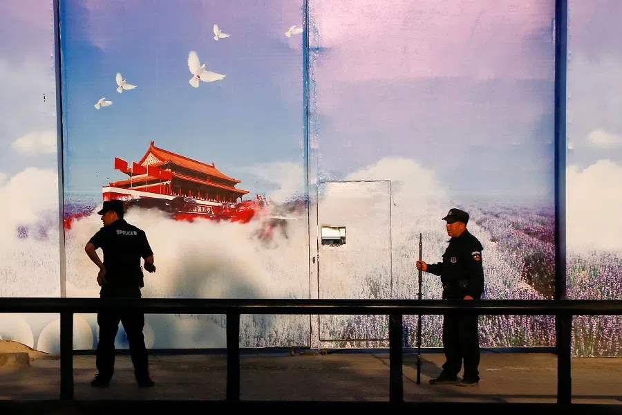 Security guards stand at the gates of what is officially known as a vocational skills education centre in Huocheng County in Xinjiang Uyghur Autonomous Region, China, 3 September 2018. (Thomas Peter/File Photo/Reuters)
