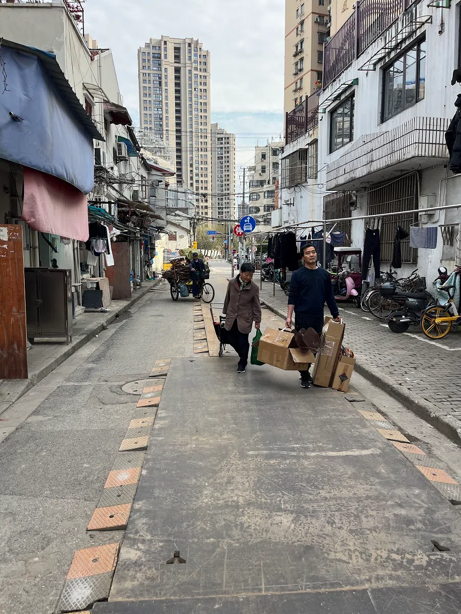 Evicted residents carry their belongings as they head to an unknown future.