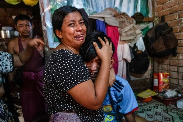 Family members cry in front of a man after he was shot dead during an anti-coup protesters crackdown in Yangon, Myanmar, on 27 March 2021.  (Reuters/Stringer)
