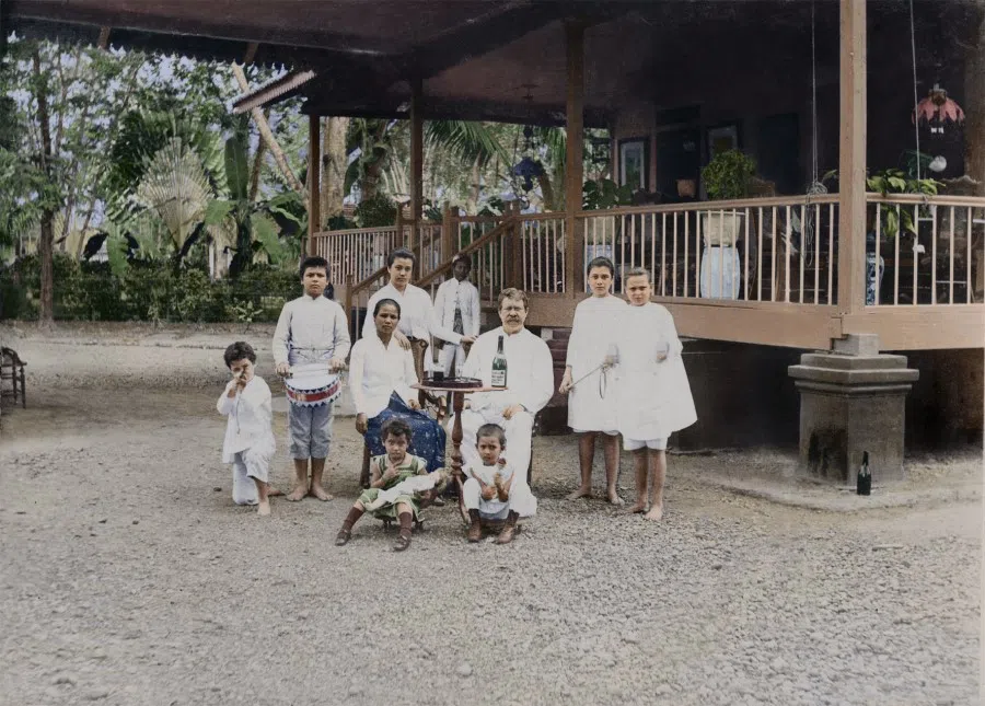 A valuable image of early Singapore showing a Eurasian family, with a Caucasian man who married a local Malay woman. Their children show both Western and Malay characteristics as early Eurasians, one of the minority groups in Singapore. While they do not live in a Western house made of bricks, their living conditions are definitely better than most local Malays. The children are barefoot, but there are servants in the house, which was rare for locals.