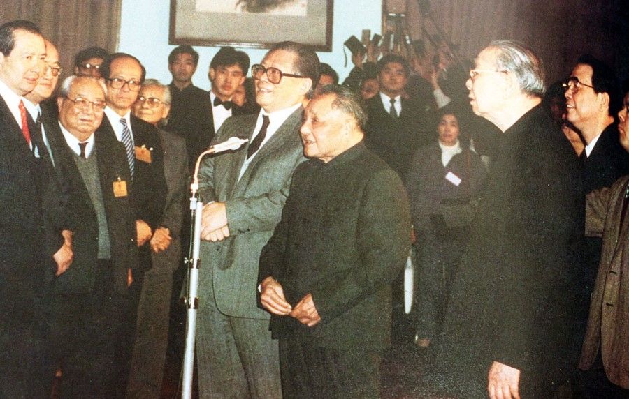 Jiang Zemin (centre, wearing glasses) and Deng Xiaoping (centre, in black) meeting members attending the ninth plenary session of the Hongkong Special Administrative Zone Basic Law Drafting Committee on 17 February 1990. (SPH)