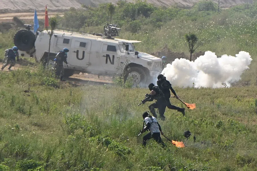 Chinese soldiers take part in a counterterrorism exercise during the multinational UN peacekeeping live exercise "Shared Destiny-2021" held by Chinese military at a tactical training base of the Chinese People's Liberation Army in Zhumadian, Henan province, China, on 15 September 2021. (Jade Gao/AFP)