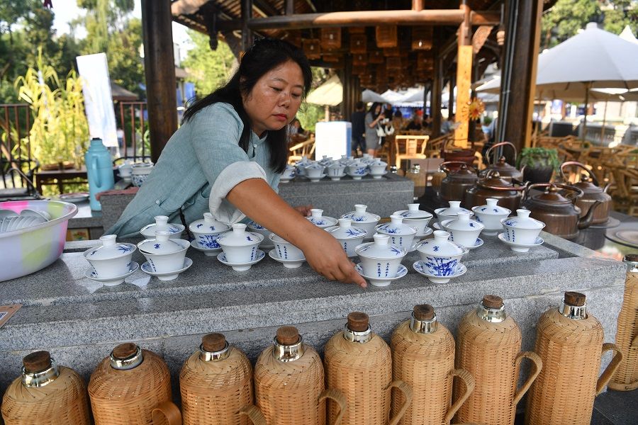 In this photo taken on 2 July 2020, a worker at an outdoor teahouse in Chengdu, China prepares tea for customers. (CNS)