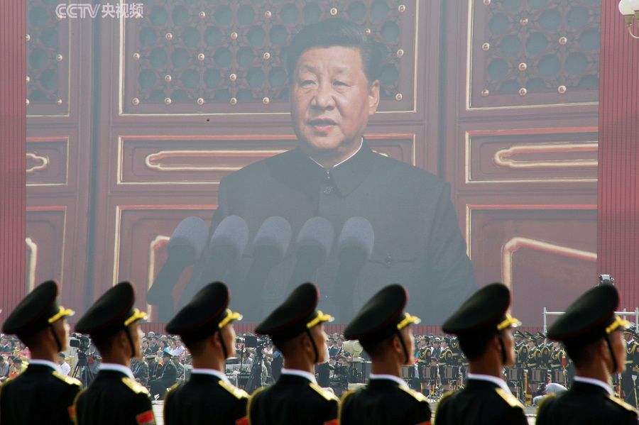Soldiers of the People's Liberation Army (PLA) are seen before a giant screen as Chinese President Xi Jinping speaks at the military parade marking the 70th founding anniversary of People's Republic of China, on its National Day in Beijing, China, 1 October 2019. (Jason Lee/File Photo/Reuters)