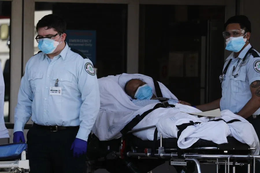Medical workers take in patients at a special coronavirus intake area at Maimonides Medical Center on April 06, 2020 in the Borough Park neighborhood of the Brooklyn borough of New York City. Hospitals in New York City, which has been especially hard hit by the coronavirus, are facing shortages of beds, ventilators and protective equipment for medical staff. (Spencer Platt/Getty Images/AFP)
