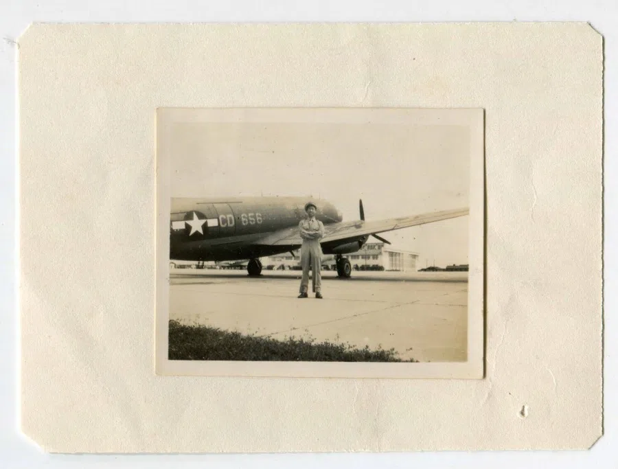 Liu beside an aircraft. Date and location not stated.